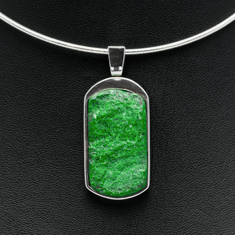 Sannan Skarn and Sterling Silver Tag Pendant on silver chain on dark leather background